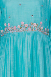 Turquoise A-line ethnic midi dress with floral embroidery and gathered waist, close-up view