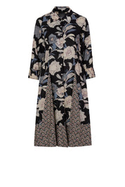 Black cotton shirt dress with floral and chevron print, front button closure, three-quarter sleeves, and tiered skirt, shown in full-length front view.