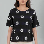 Abstract print short sleeve top with circular patterns.