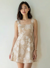Woman wearing a beige floral dress