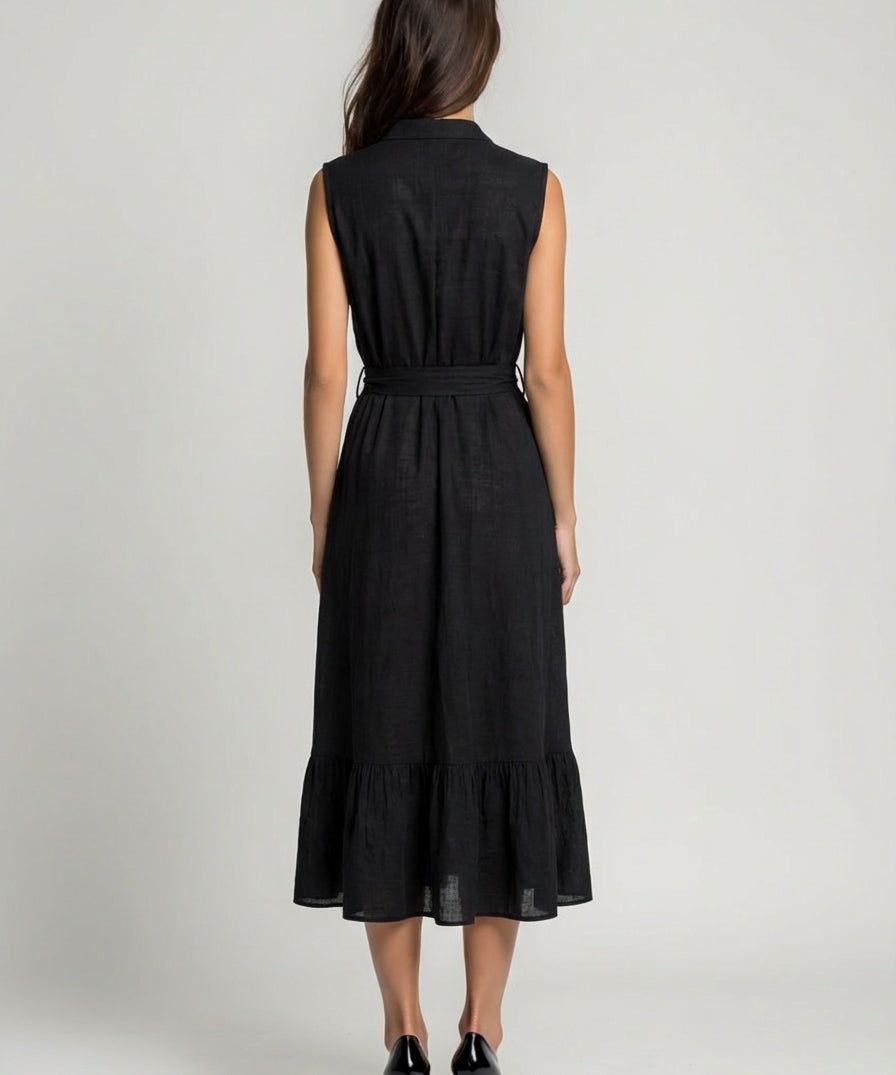 Woman wearing a black sleeveless dress on a plain background
