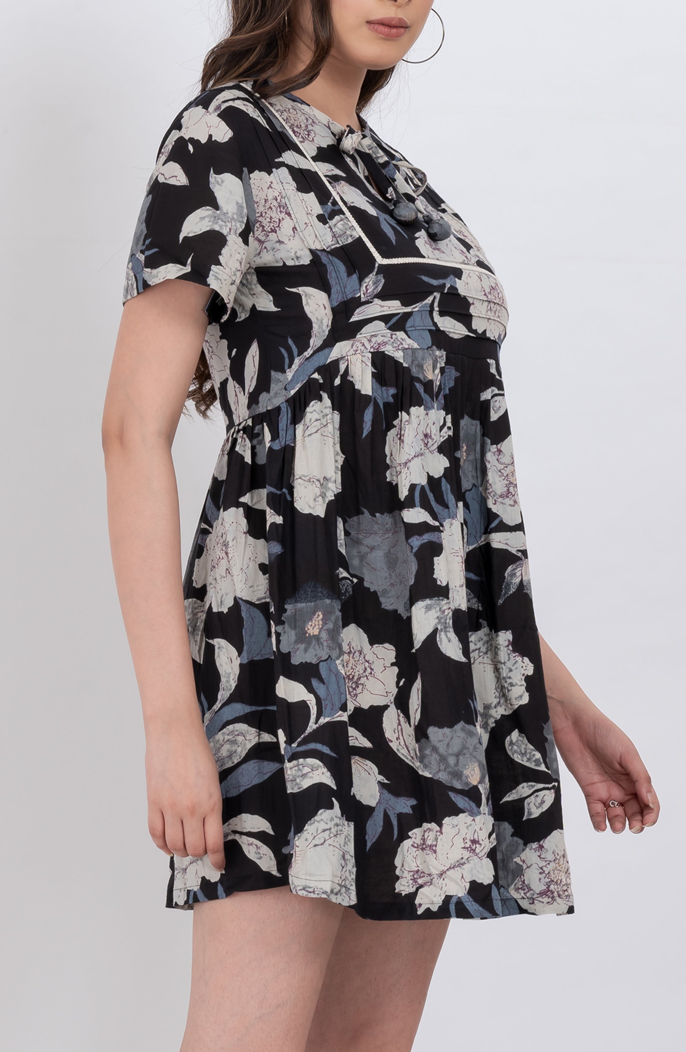 Sleeveless floral dress with tie neck and relaxed babydoll fit