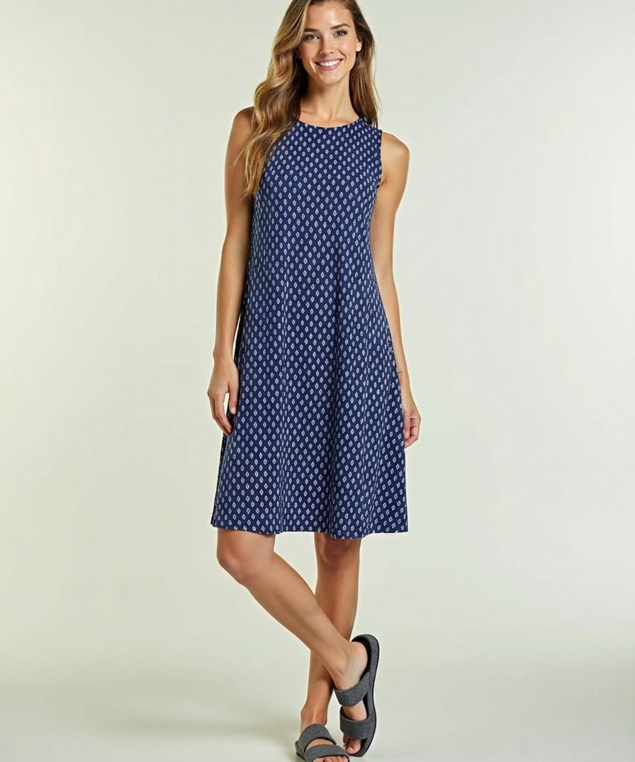 Woman wearing a blue polka dot dress on a light background