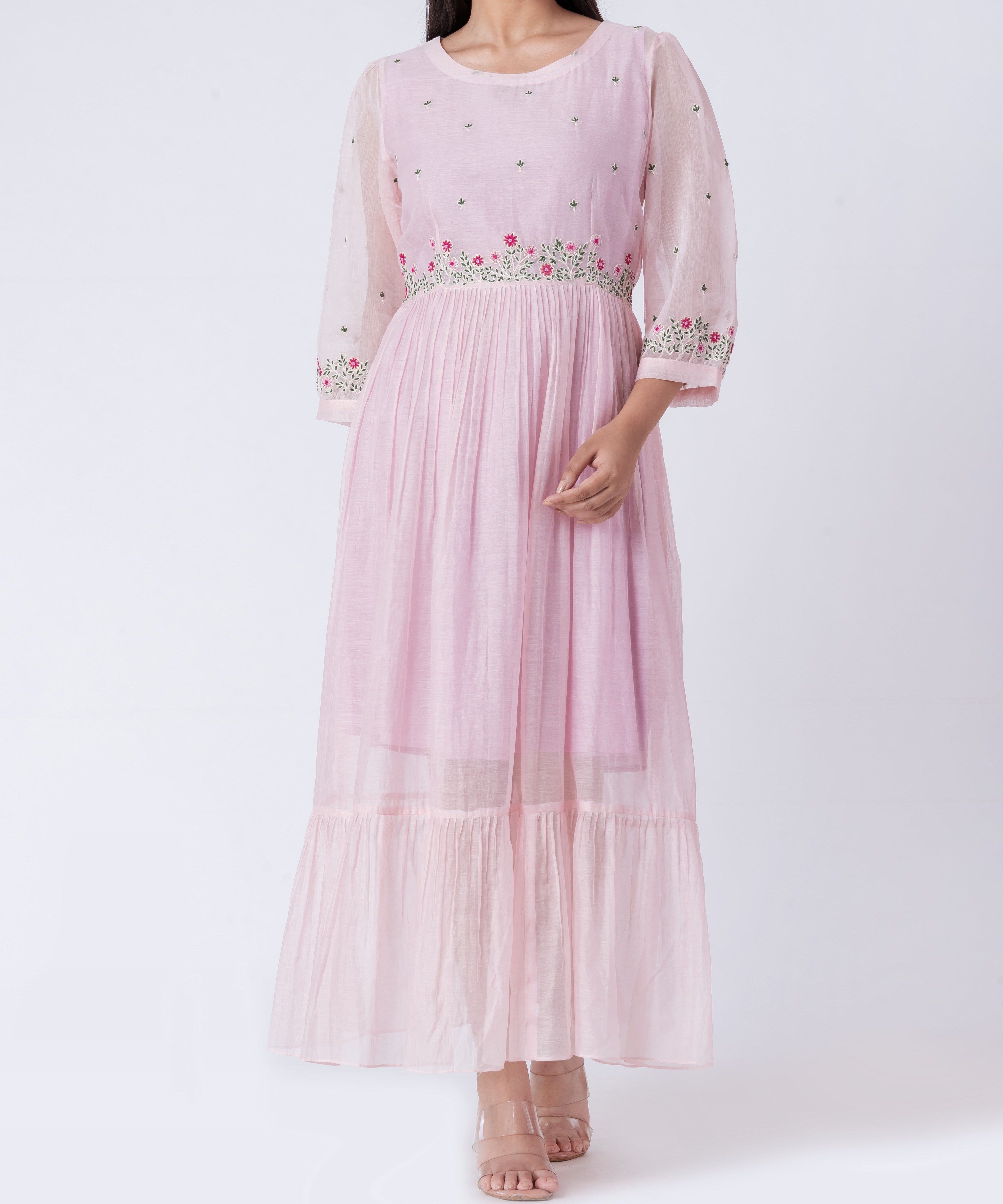  Close-up shot of the intricate floral embroidery on the cotton silk dress fabric.