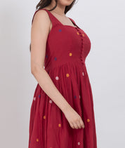  Comfortable handwoven cotton polka dot dress with button front and A-line cut, perfect for sunny days.