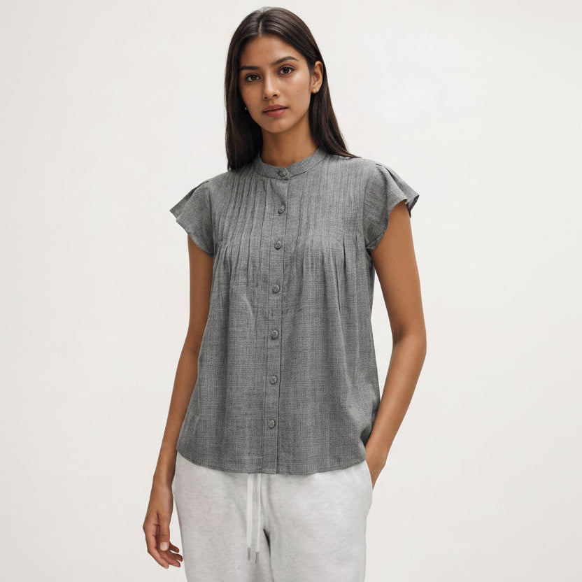 Woman wearing a gray checkered blouse with short sleeves on a white background