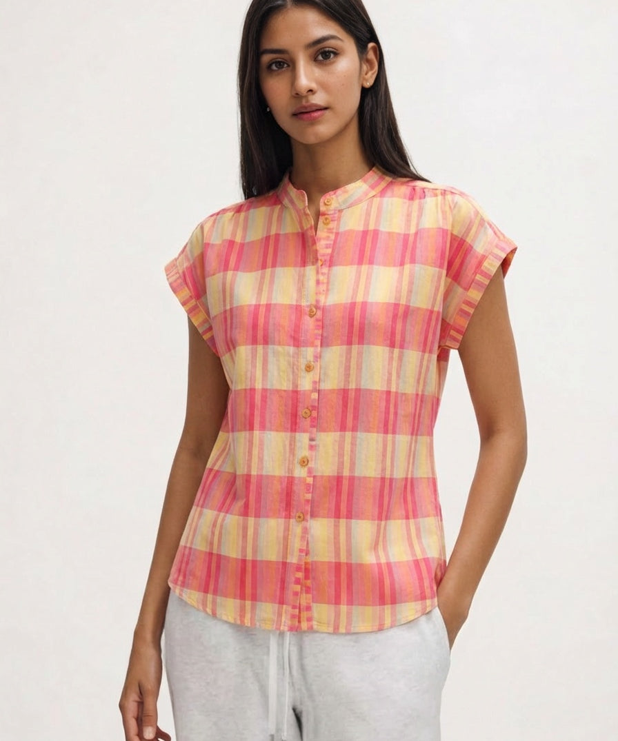 Woman wearing a pink and yellow checkered shirt on a white background