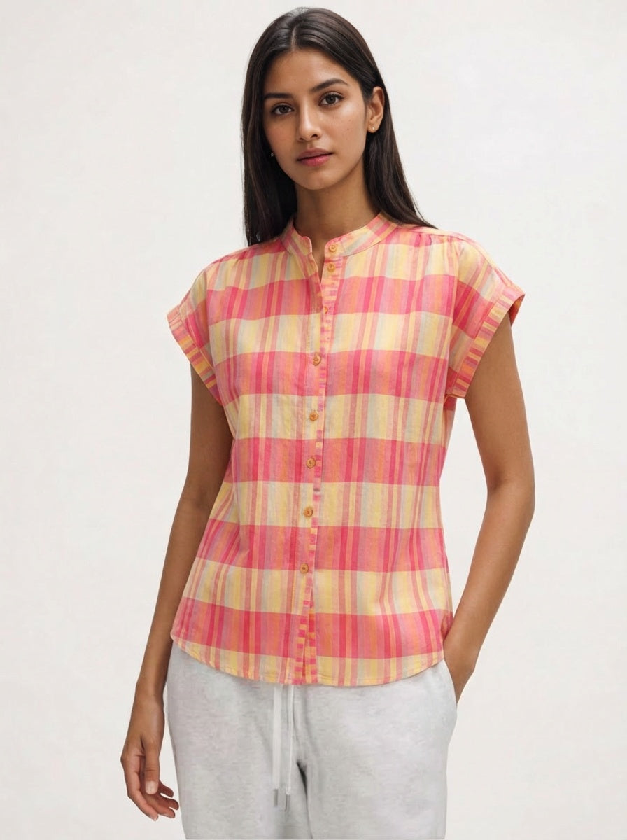 Woman wearing a pink and yellow checkered shirt on a white background