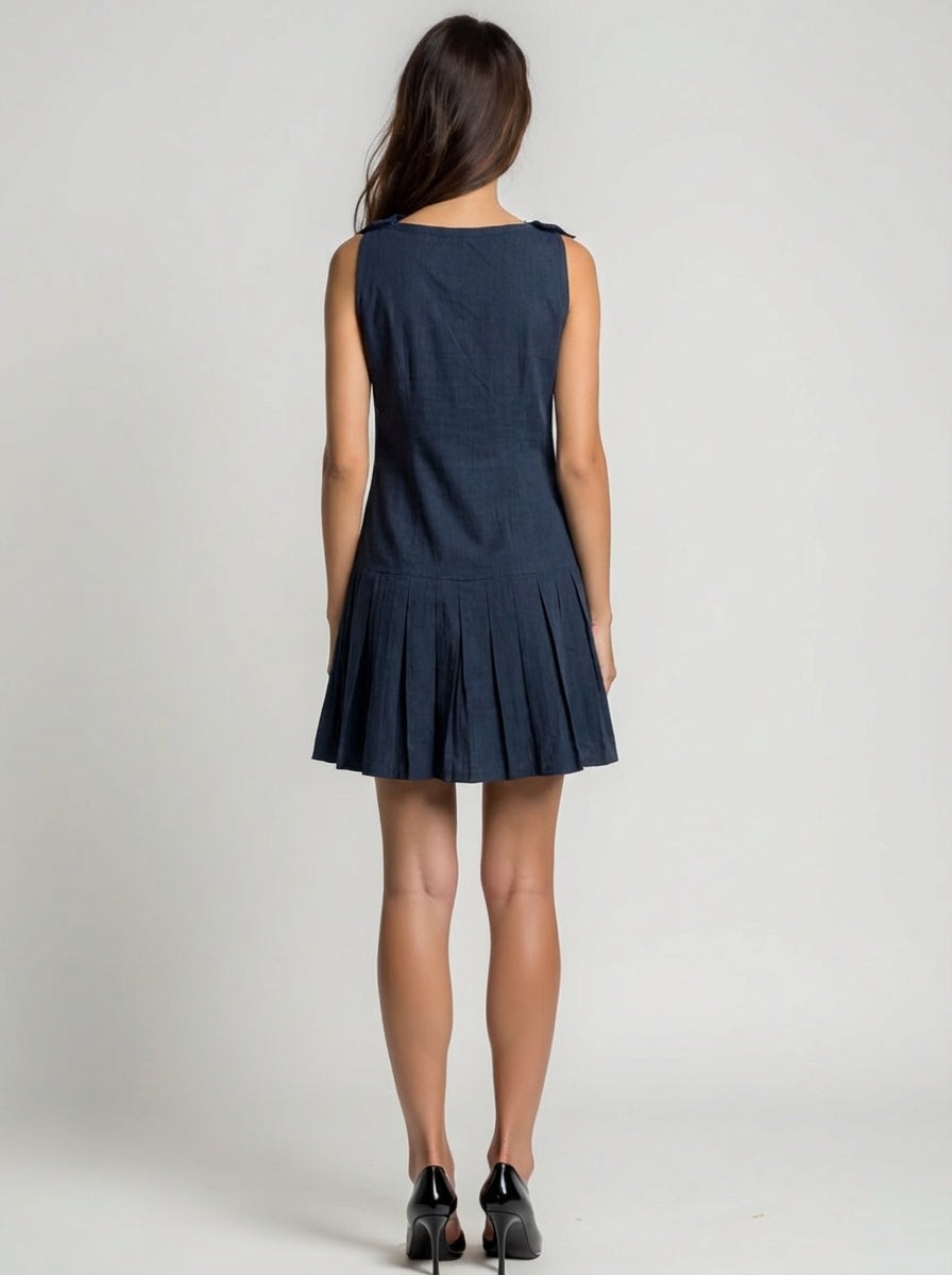 Woman wearing a navy blue dress on a plain background