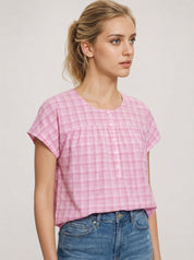 Woman wearing a pink checkered shirt best ootd