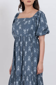 Feminine floral puff sleeve dress with square neck and flowy skirt