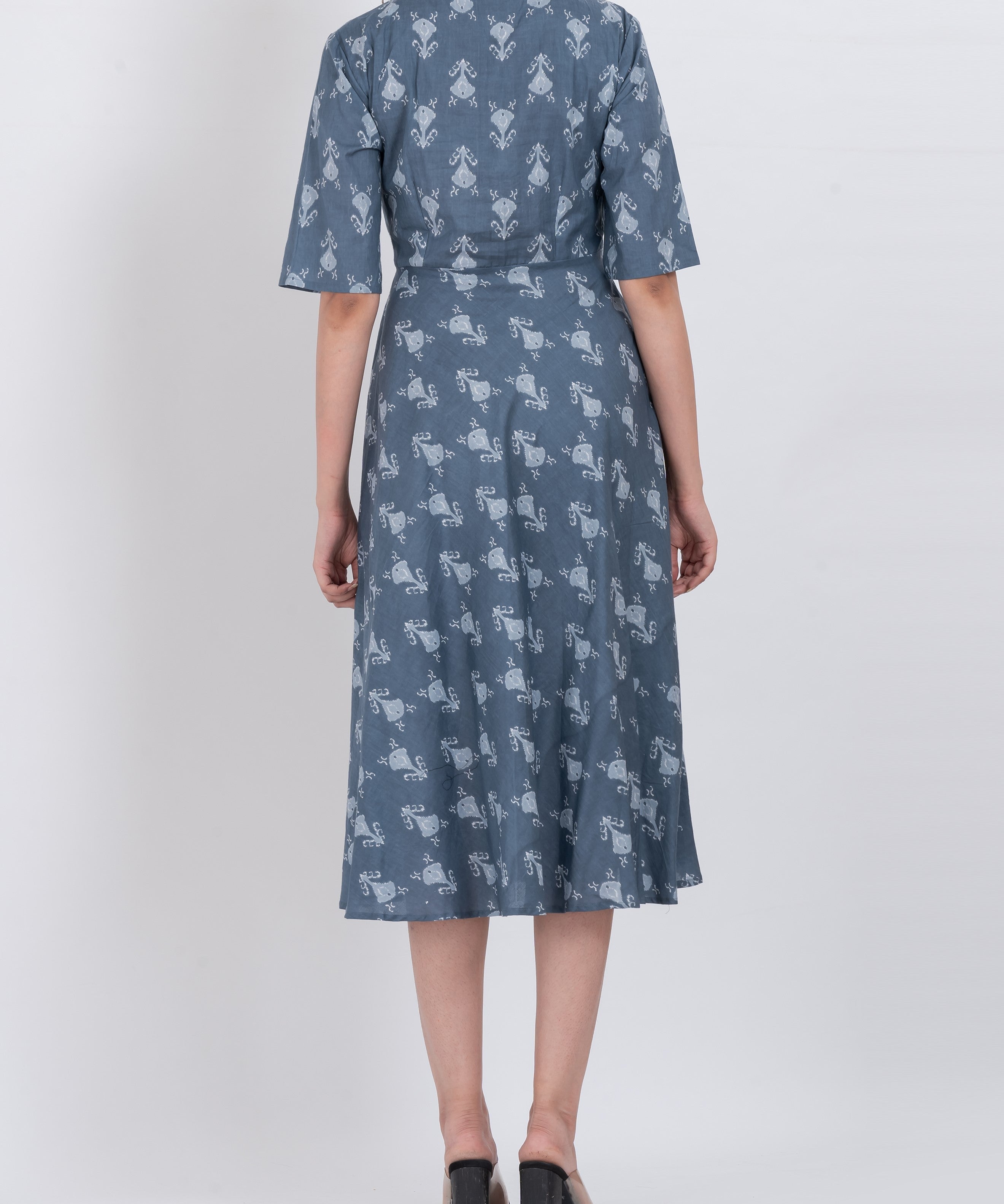 Model wearing a floral collared midi dress with short sleeves and a flattering A-line cut.