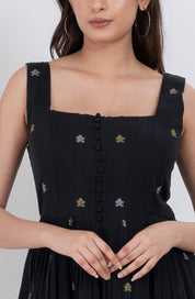 Full-length view of floral embroidered handwoven cotton dress with button front and A-line style.