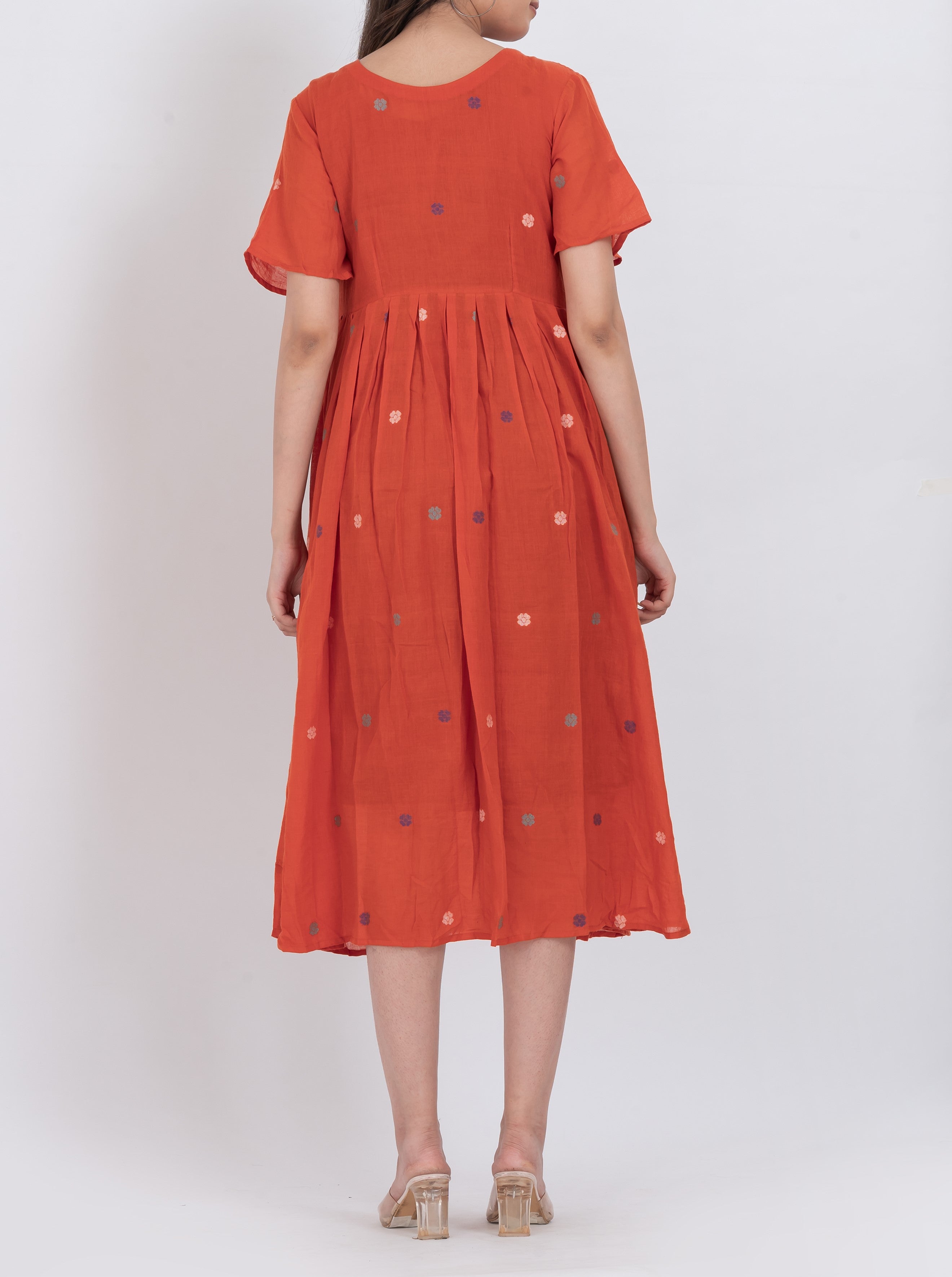 A-line floral handwoven cotton dress with short sleeves and pleated design for a comfortable fit.