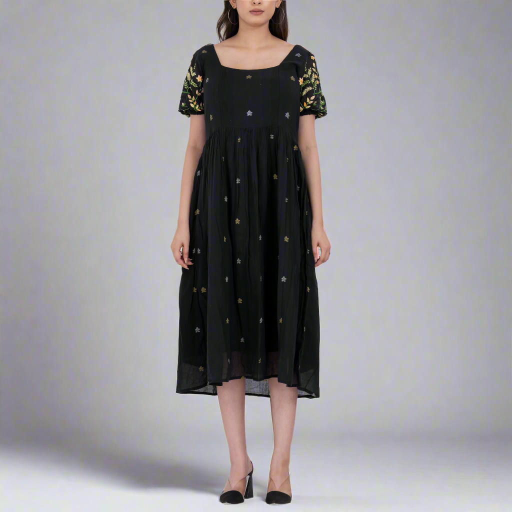 Front view of the floral embroidered handwoven cotton dress with a square neckline and puff sleeves