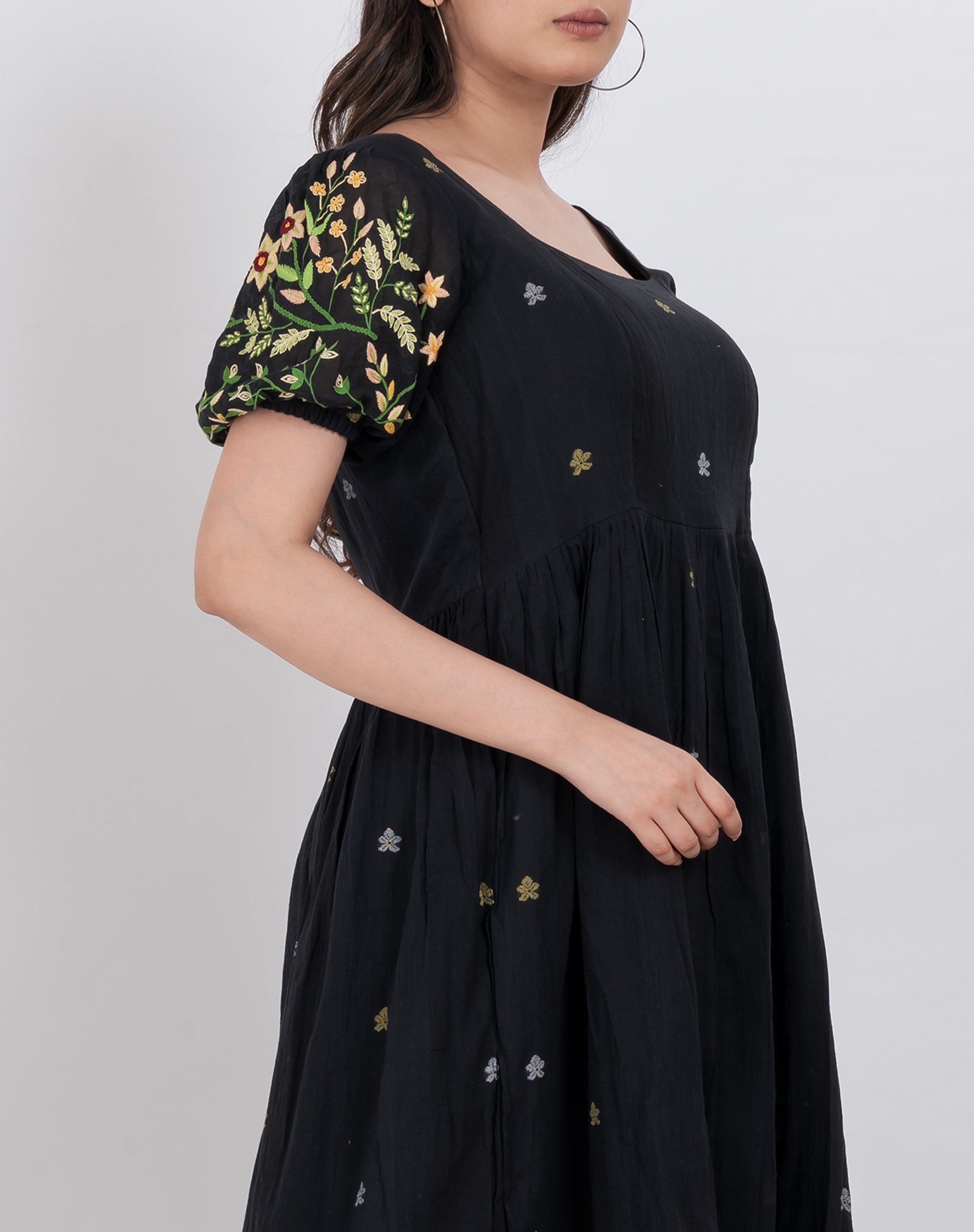  Side view showcasing the tiered style and square neckline of the floral handwoven cotton dress.