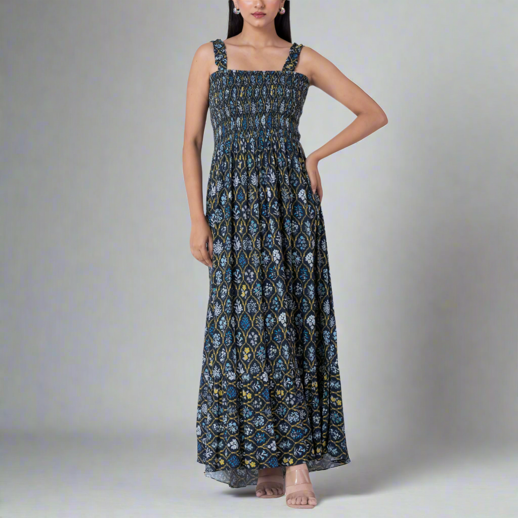 Model wearing a floral print smocked maxi dress with adjustable straps.