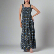 Model wearing a floral print smocked maxi dress with adjustable straps.