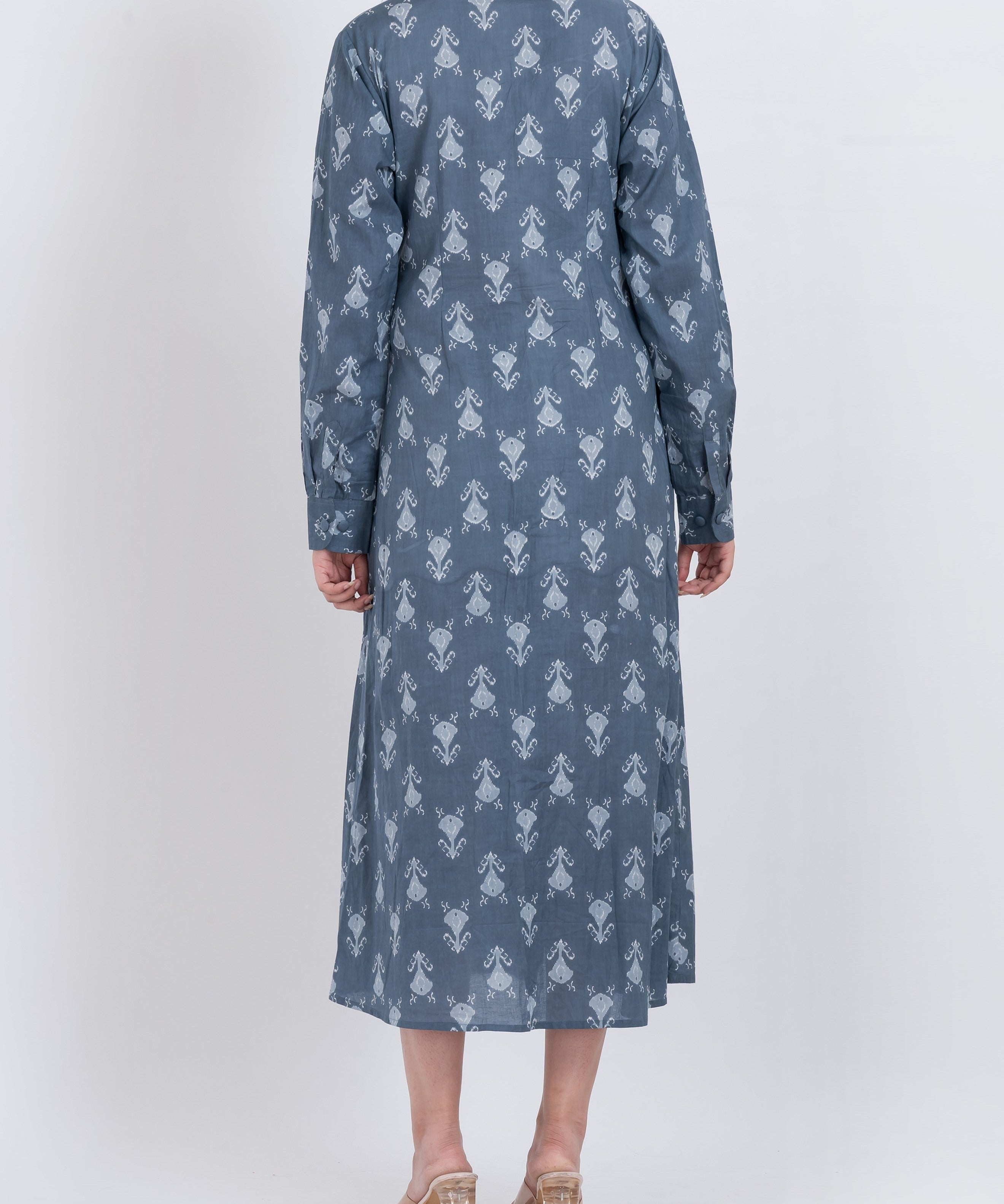  Close-up shot of the floral print on a midi-length shirt dress, highlighting the intricate design.