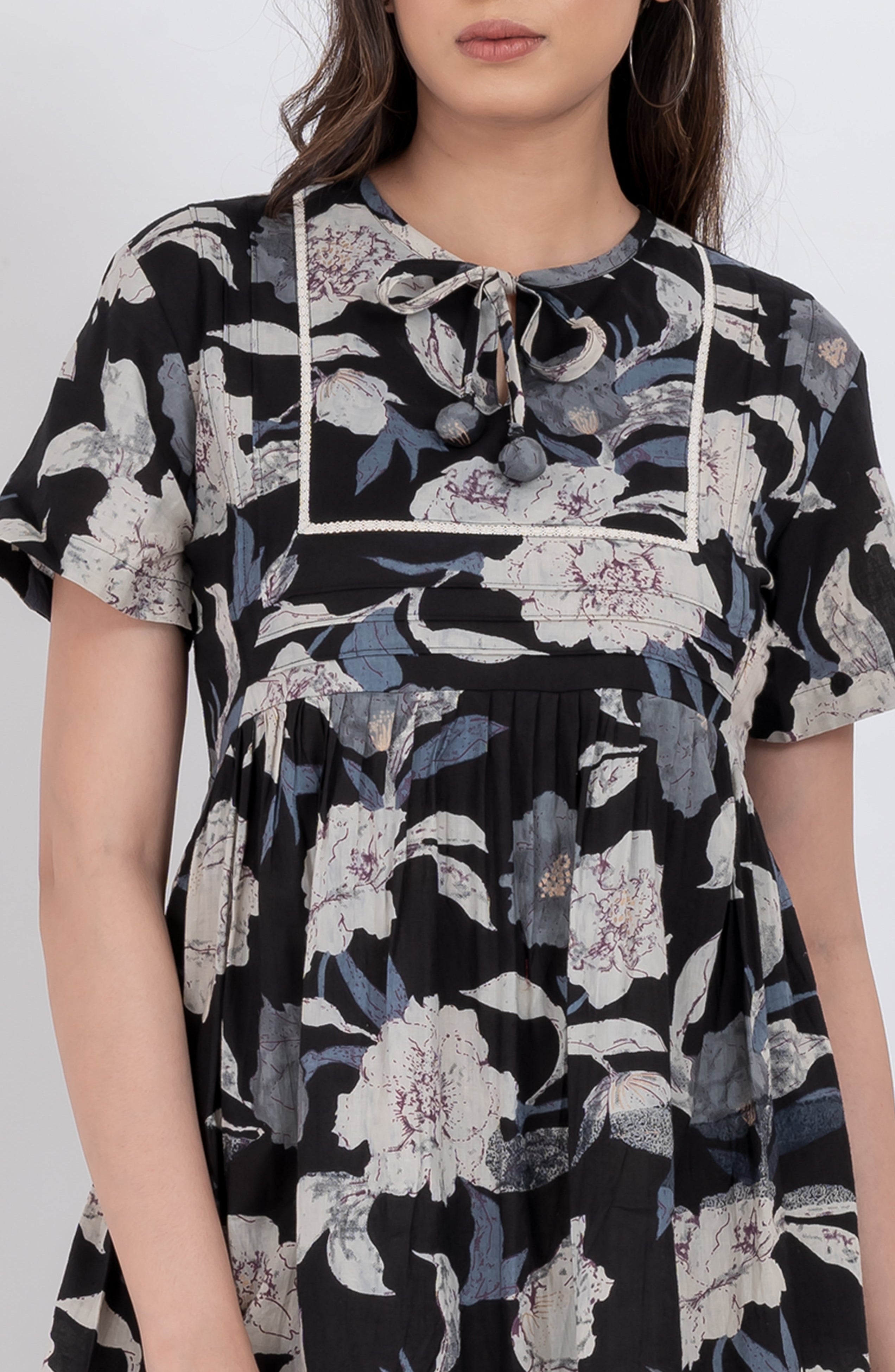 Cute floral babydoll dress with V-neck tie neck detail and flowy skirt