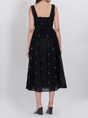 Handwoven cotton dress featuring floral embroidery and button front closure.
