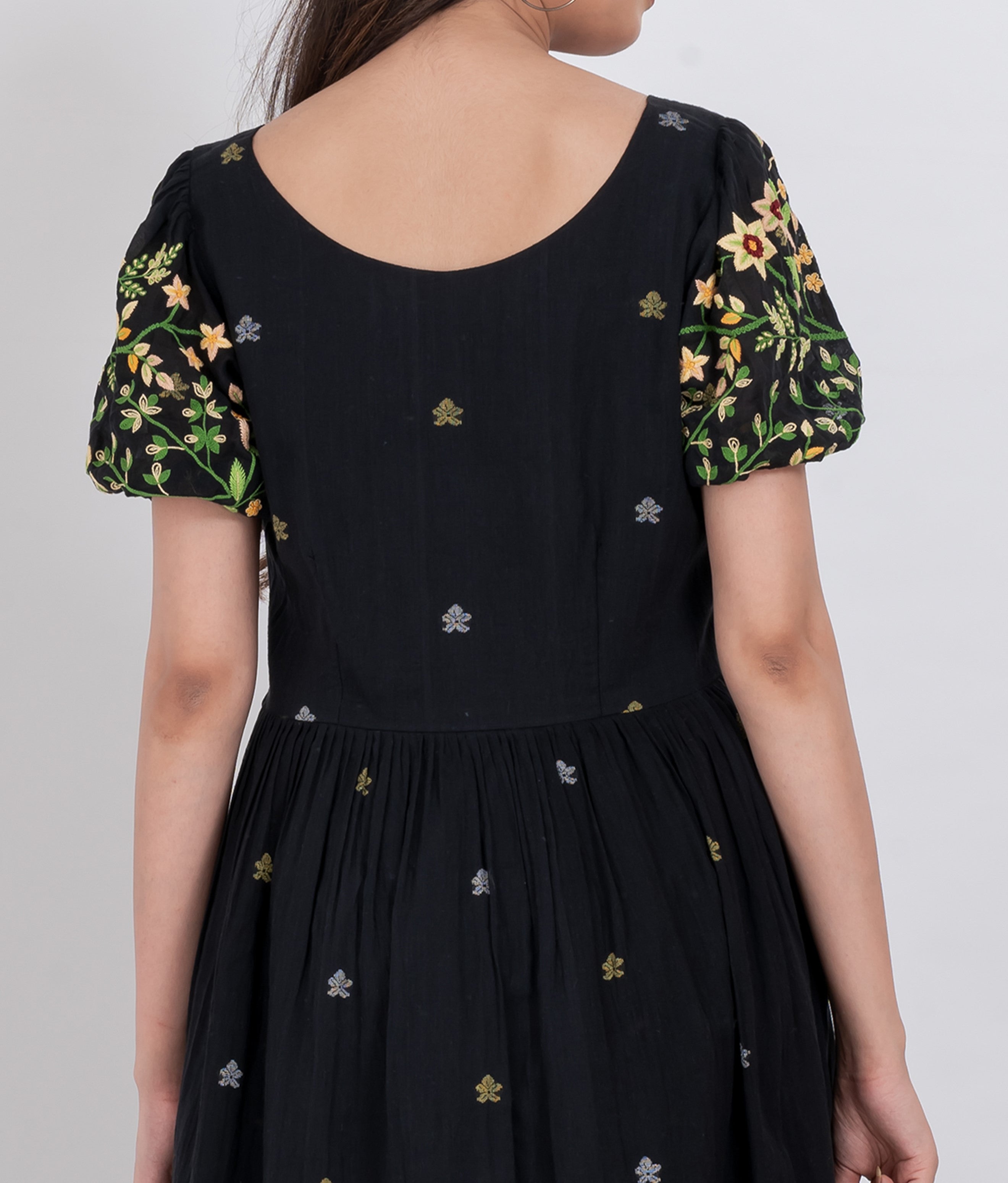  A closer look at the puff sleeve and floral embroidery on the handwoven cotton dress.