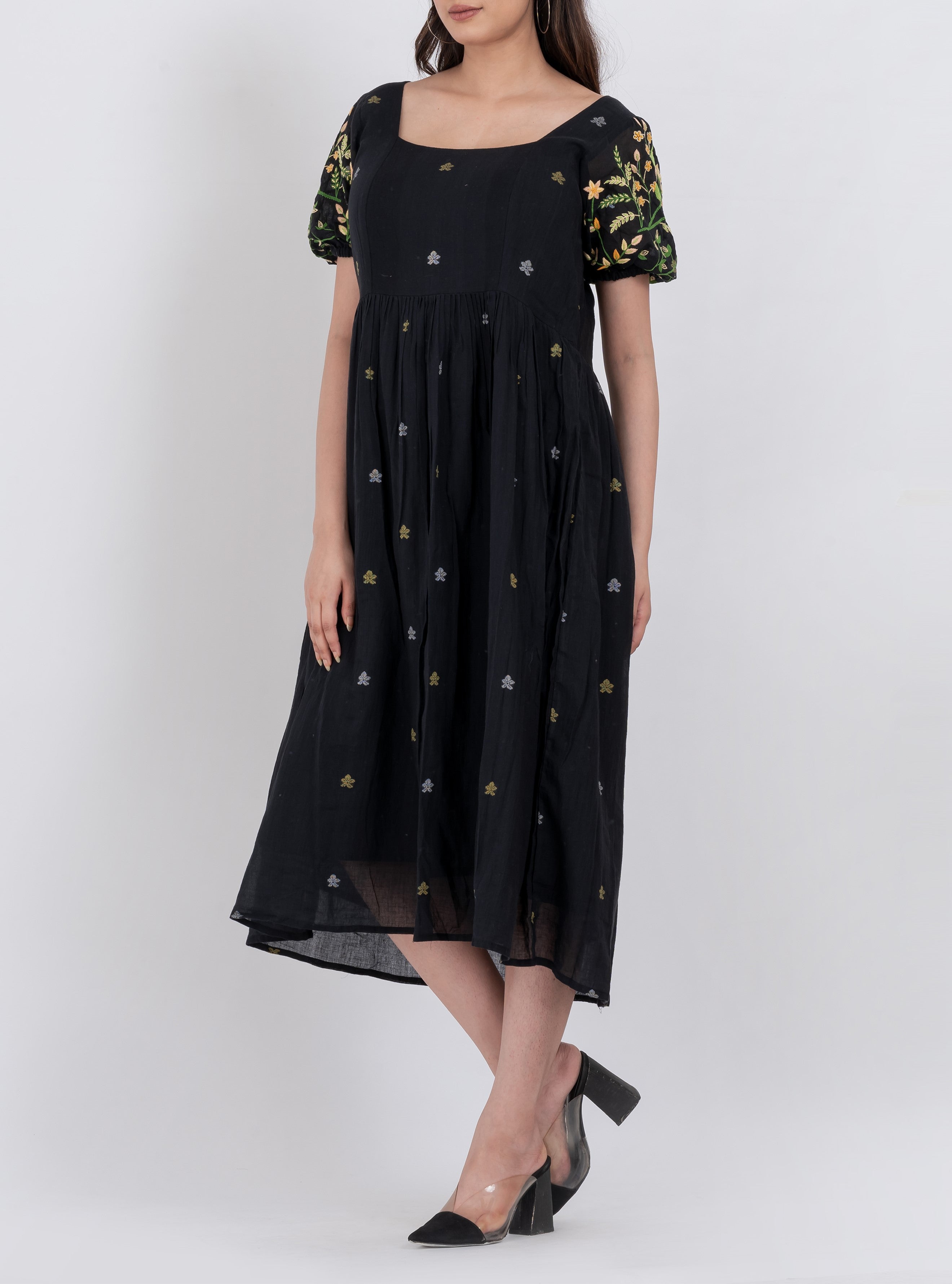  Handwoven cotton floral dress featuring tiered design and a flowing A-line silhouette.