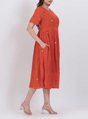 Handwoven cotton floral embroidered dress featuring pleated A-line design and short sleeves.