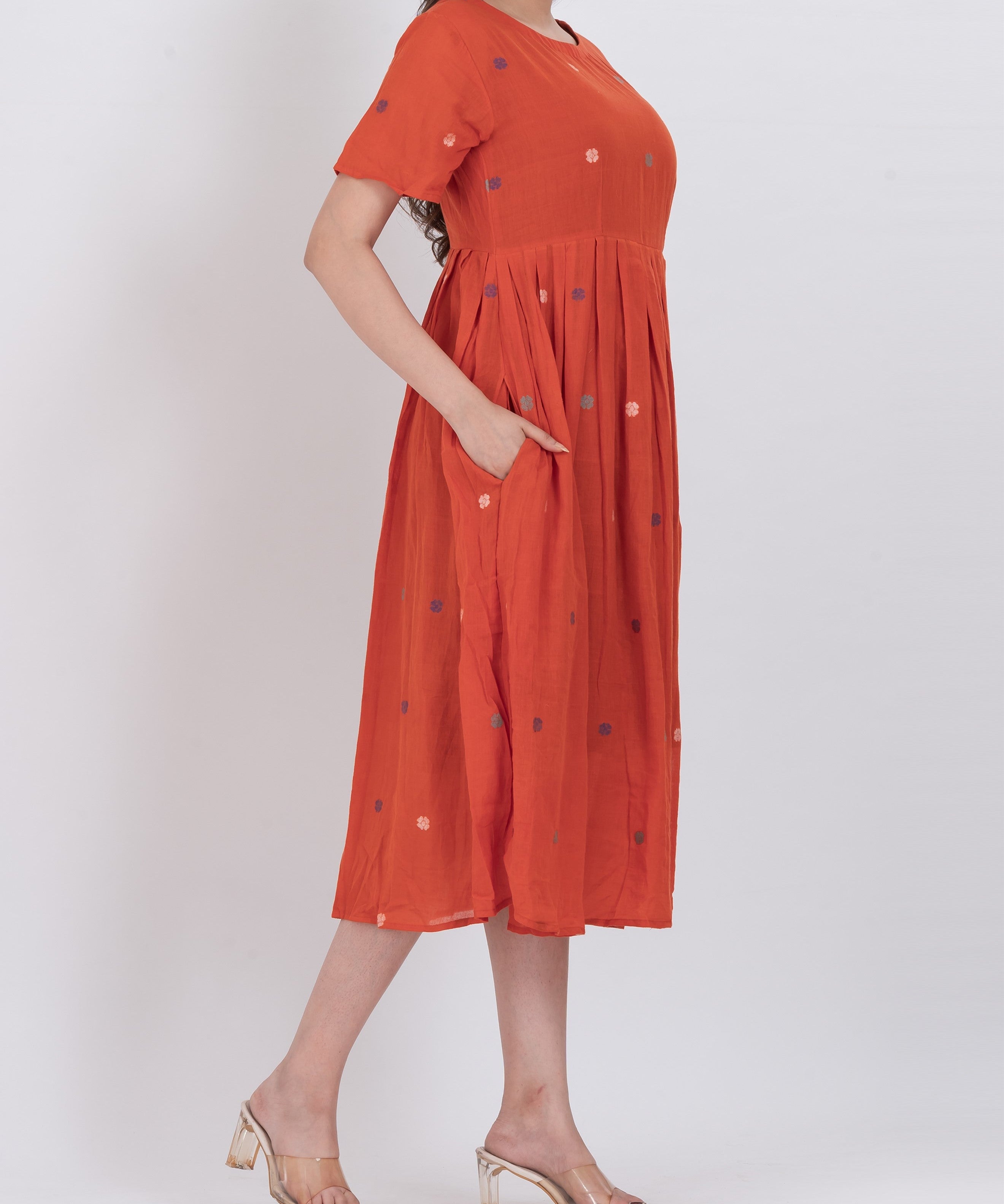Handwoven cotton floral embroidered dress featuring pleated A-line design and short sleeves.