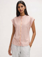 Woman wearing a striped shirt with a plain background