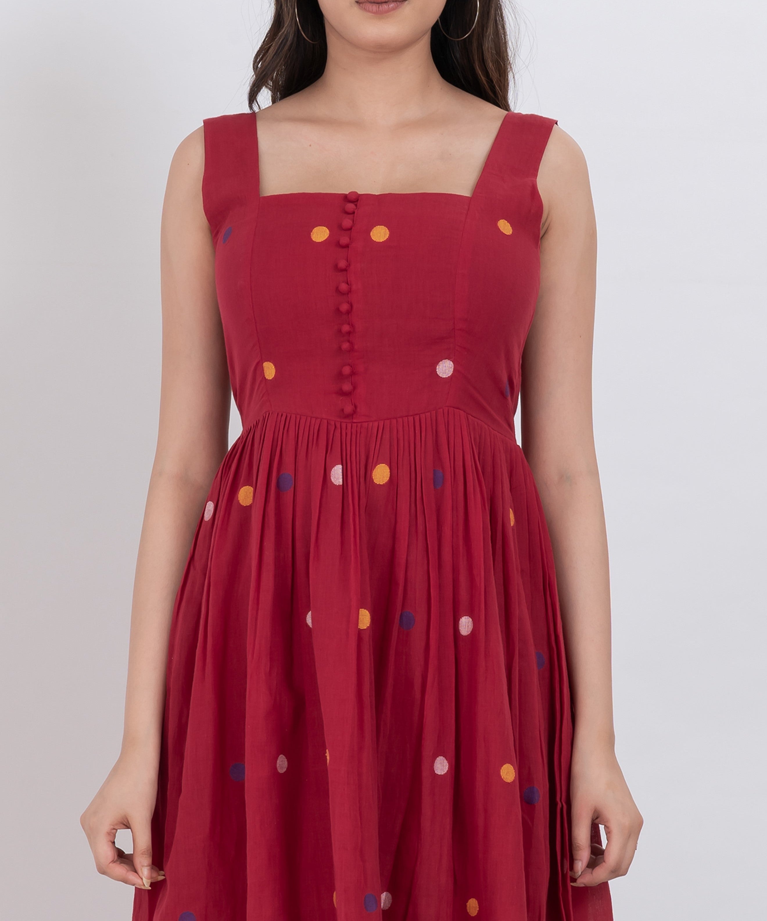 Handwoven cotton polka dot dress with button front closure and A-line silhouette.