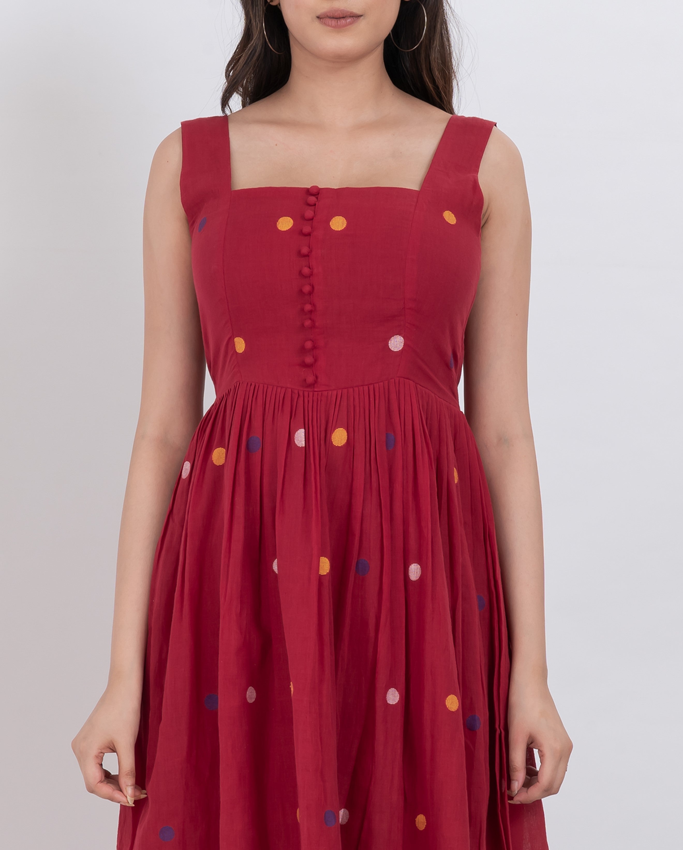 Handwoven cotton polka dot dress with button front closure and A-line silhouette.