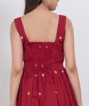 Handwoven cotton polka dot dress with pleated A-line style and button front closure.
