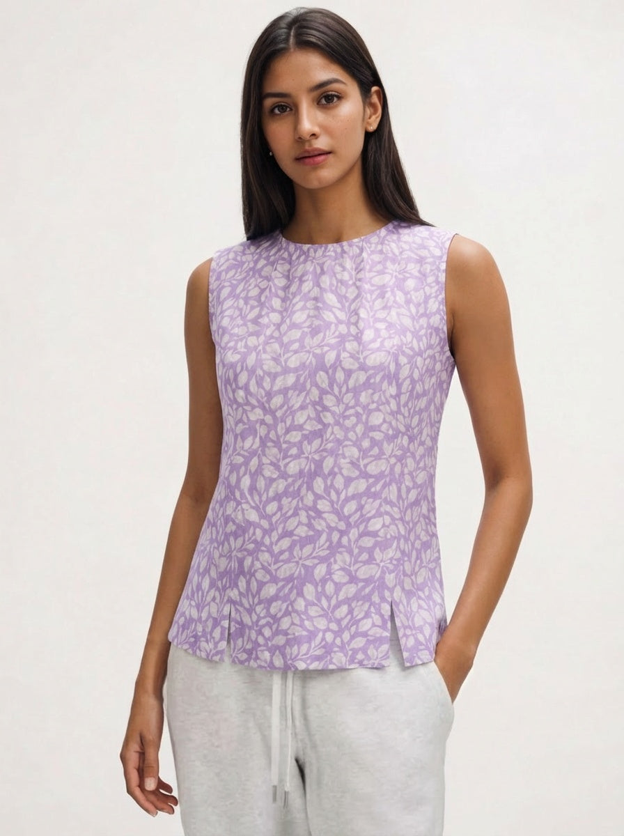 Woman wearing a purple sleeveless top with a white background