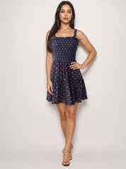Navy sundress with red rosebud print design
