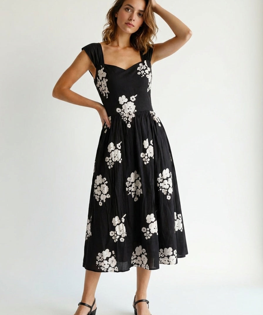 Woman wearing a black dress with white floral patterns party mood forck gown