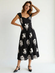 Woman wearing a black dress with white floral patterns party mood forck gown