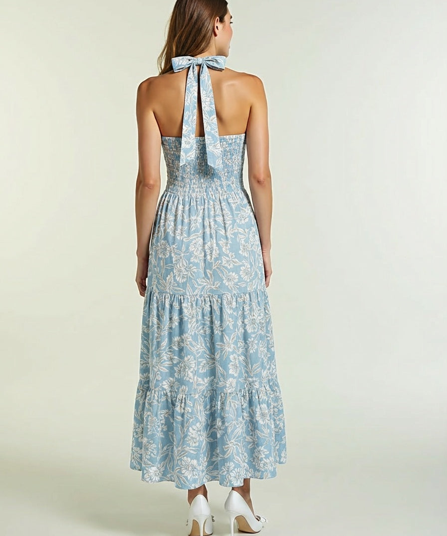 Woman wearing a blue floral dress with a halter neck