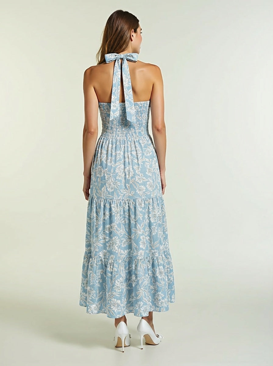 Woman wearing a blue floral dress with a halter neck