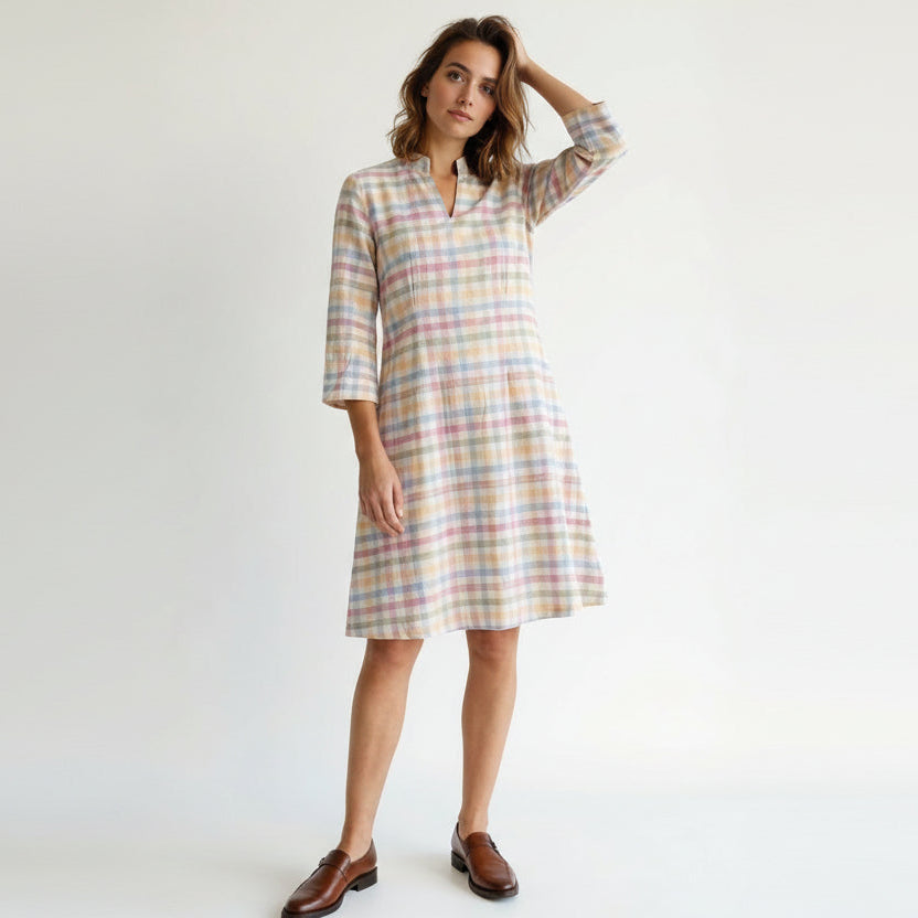 Woman wearing a plaid dress on a white background