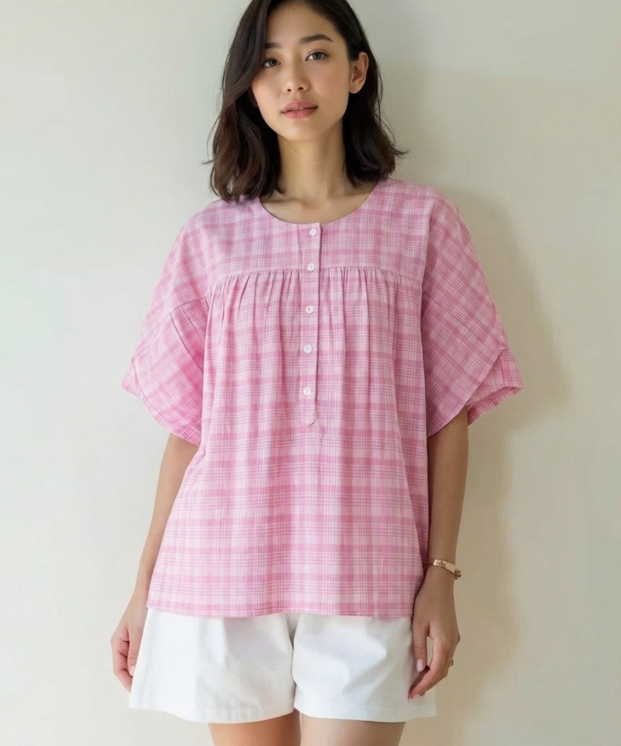 Woman wearing a pink checkered blouse