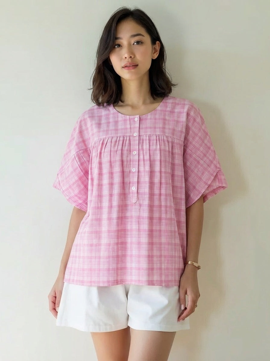 Woman wearing a pink checkered blouse