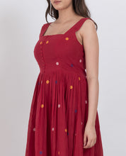Handwoven cotton polka dot dress with button details and A-line silhouette, ideal for summer wear.
