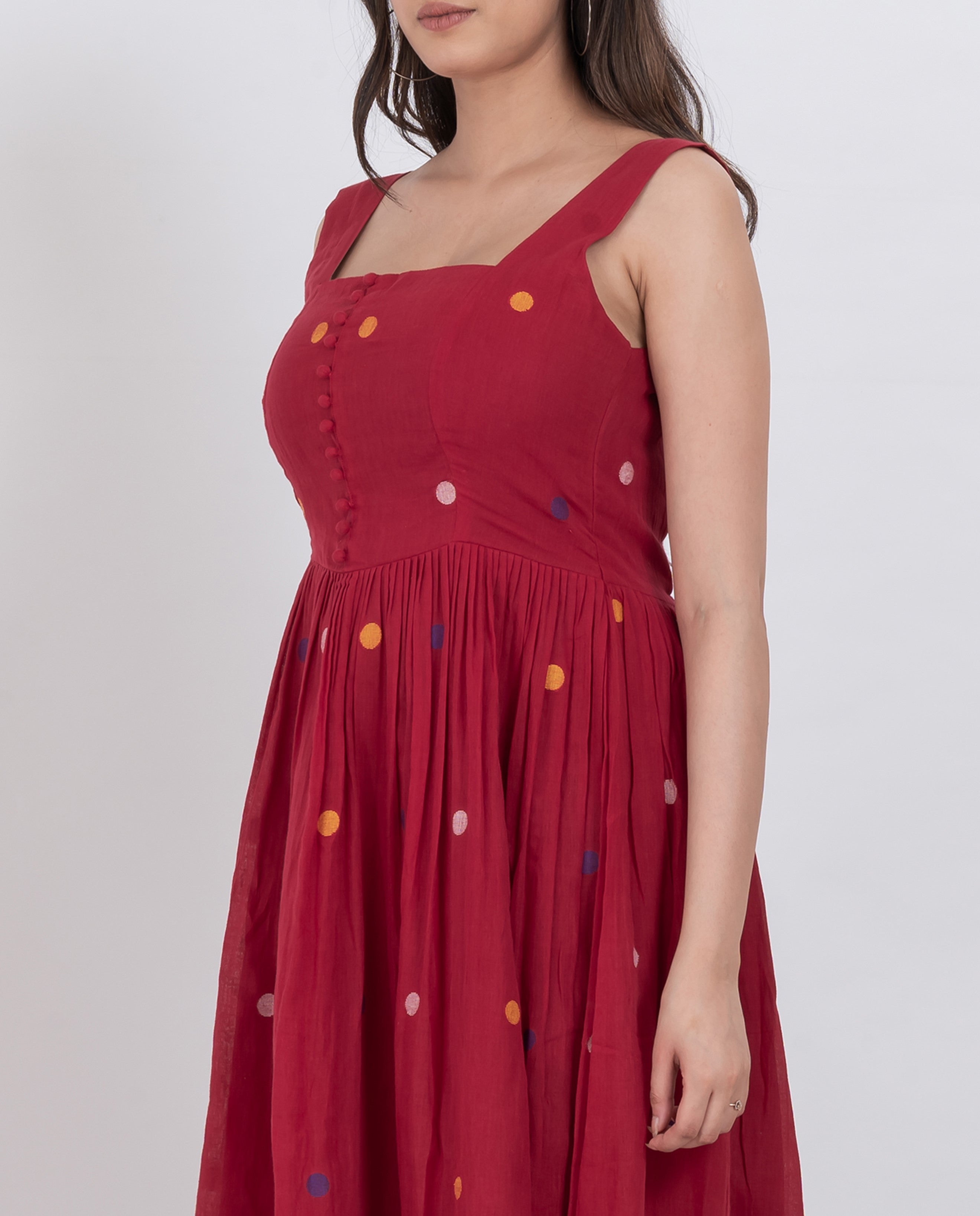 Handwoven cotton polka dot dress with button details and A-line silhouette, ideal for summer wear.