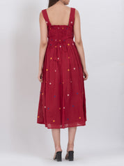Polka dot handwoven cotton dress with button front and pleated A-line design.