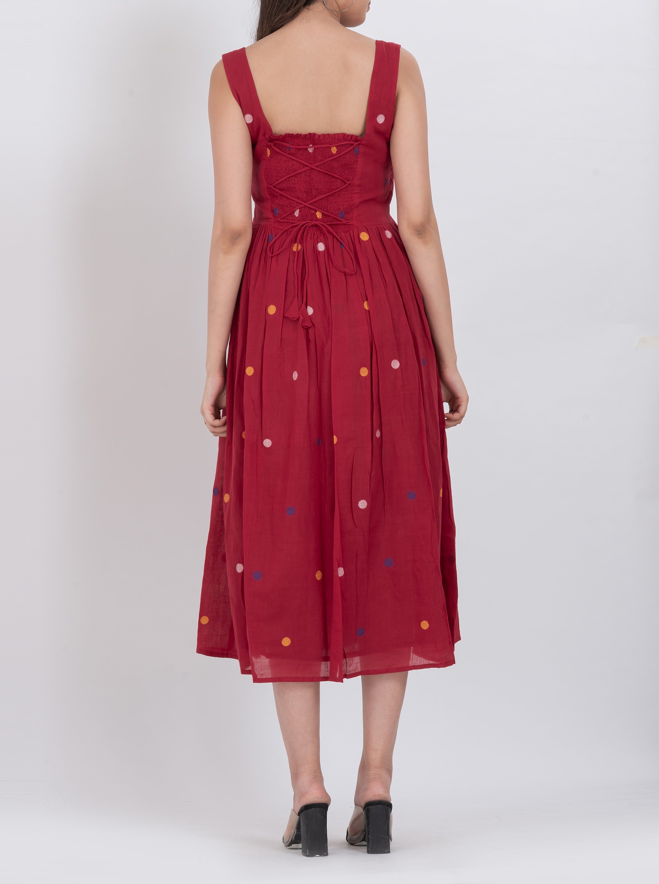Polka dot handwoven cotton dress with button front and pleated A-line design.