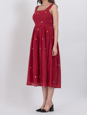 Polka dot handwoven cotton dress with A-line fit and button front, offering a flattering silhouette.