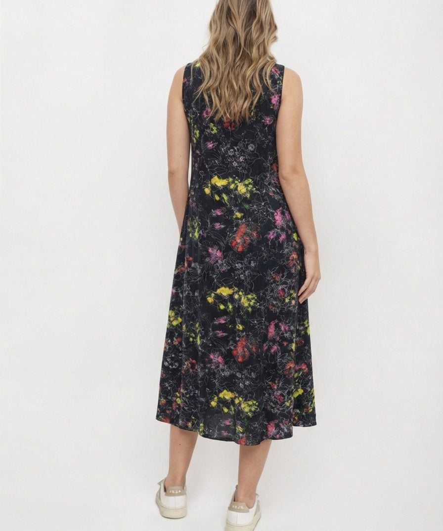 Woman wearing a sleeveless floral dress on a white background